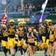 WVU Football team led Reid Carrico with US and WV flag and cheerleaders