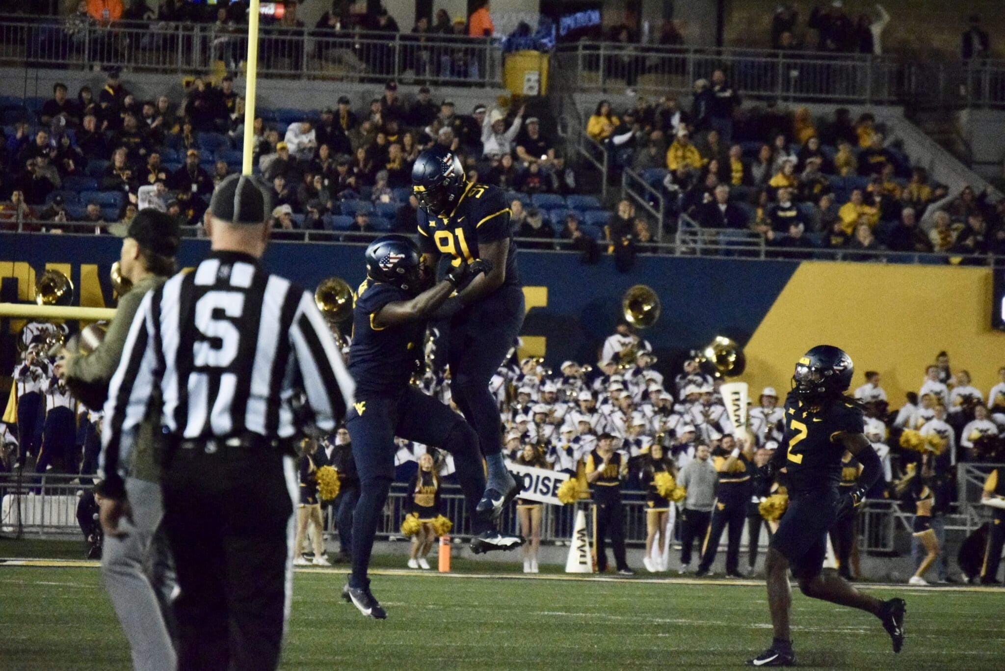 WVU Football Defense with Sean Martin and Aubrey Burks celebrates over BYU