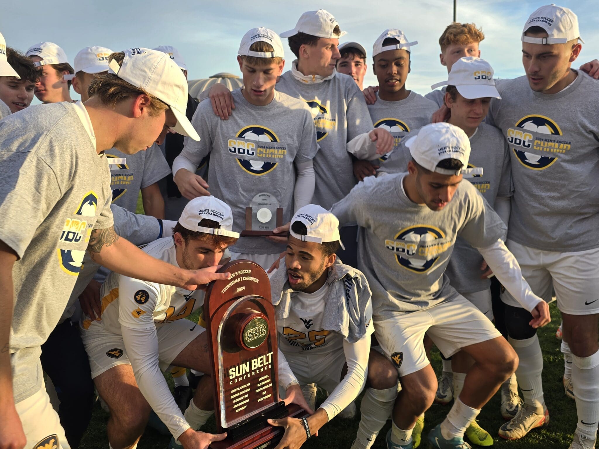 WVU soccer with conference championship trophy