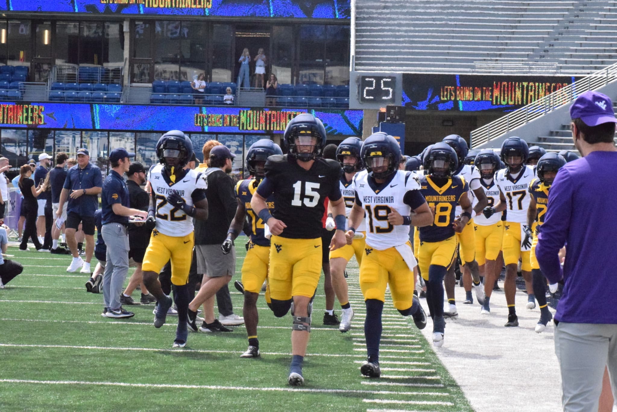 WVU Football running on field for spring scrimmage