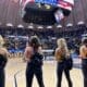 WVU cheerleaders at basketball game during US anthem stock