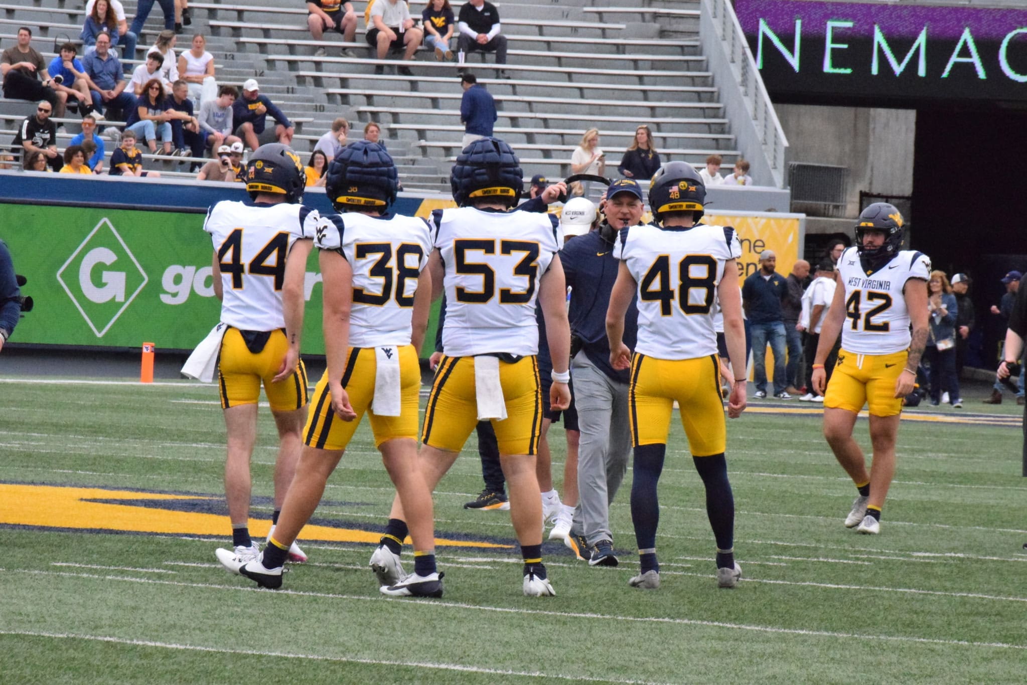 WVU Football HC Rich Rodriguez with players during Spring Showcase