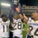 WVU Football players with Black Diamond Trophy