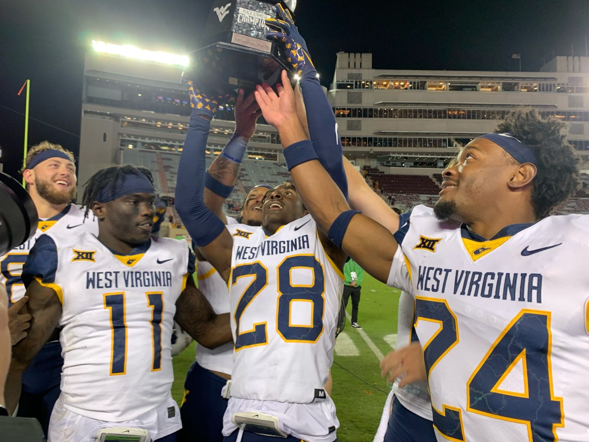 WVU Football players with Black Diamond Trophy
