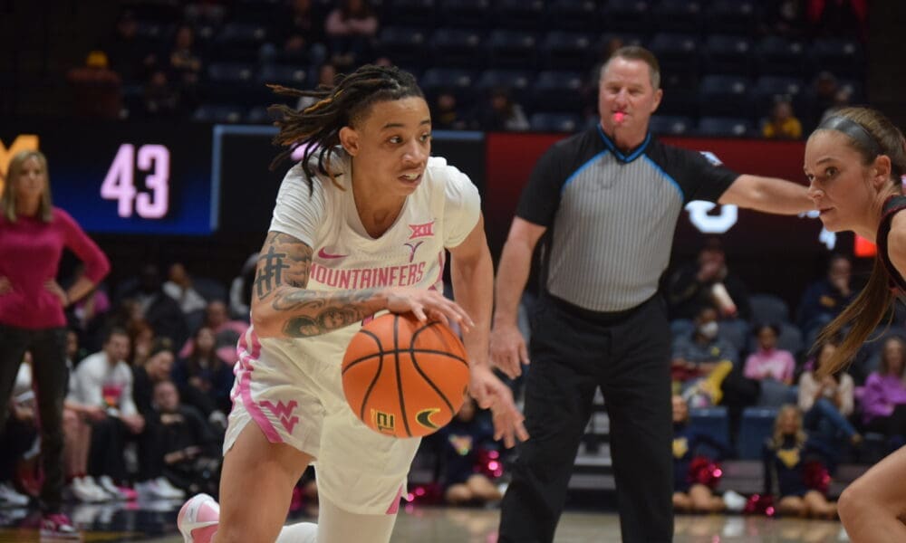 WVU Women's Basketball guard JJ Quinerly dribbles the ball during the Mountaineers' February 17 game against No. 23 Oklahoma.