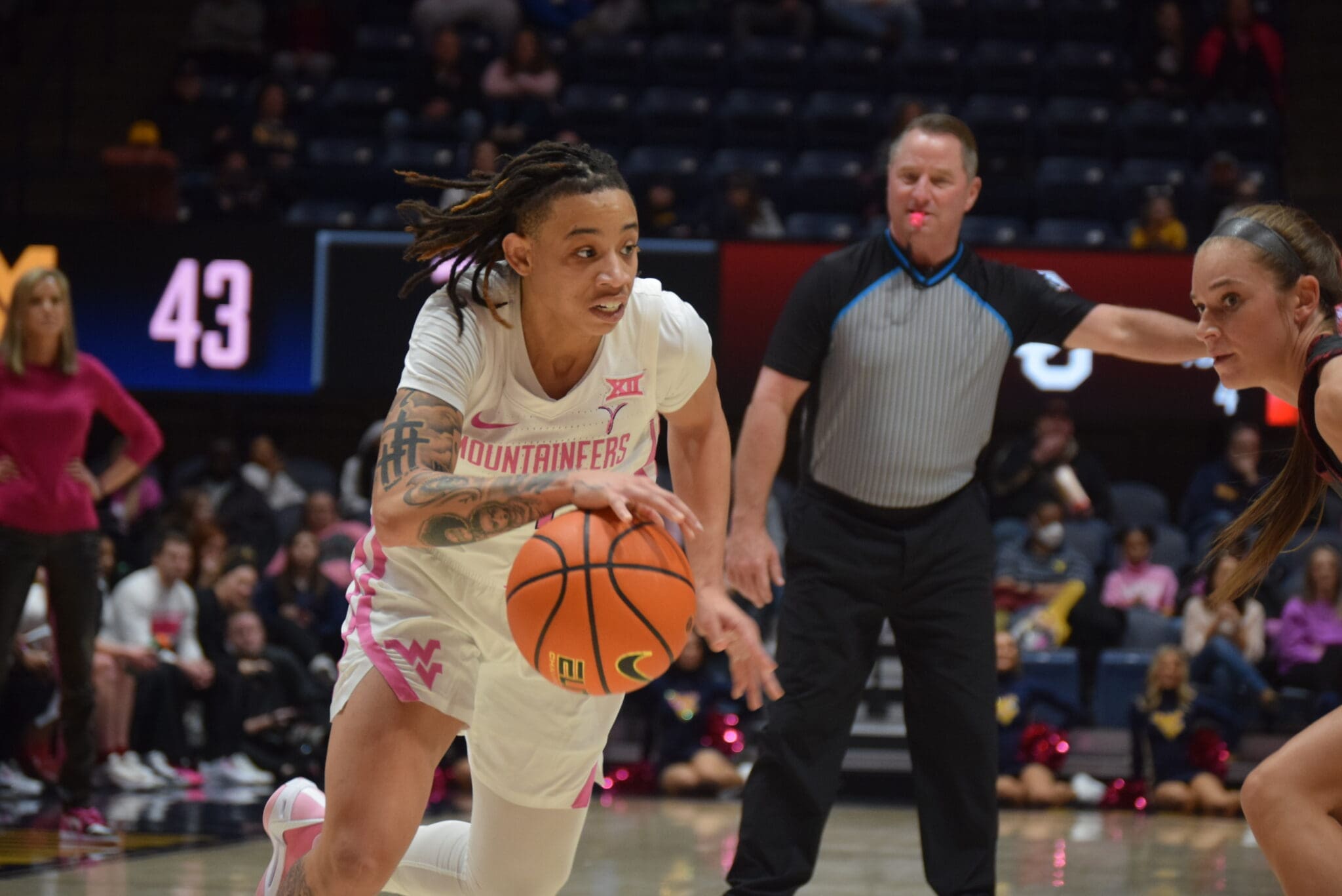 WVU Women's Basketball guard JJ Quinerly dribbles the ball during the Mountaineers' February 17 game against No. 23 Oklahoma.