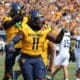 WVU Football TJ Jackson and Aubrey Burks celebrate a turnover
