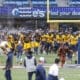 WVU football team running on field for spring game