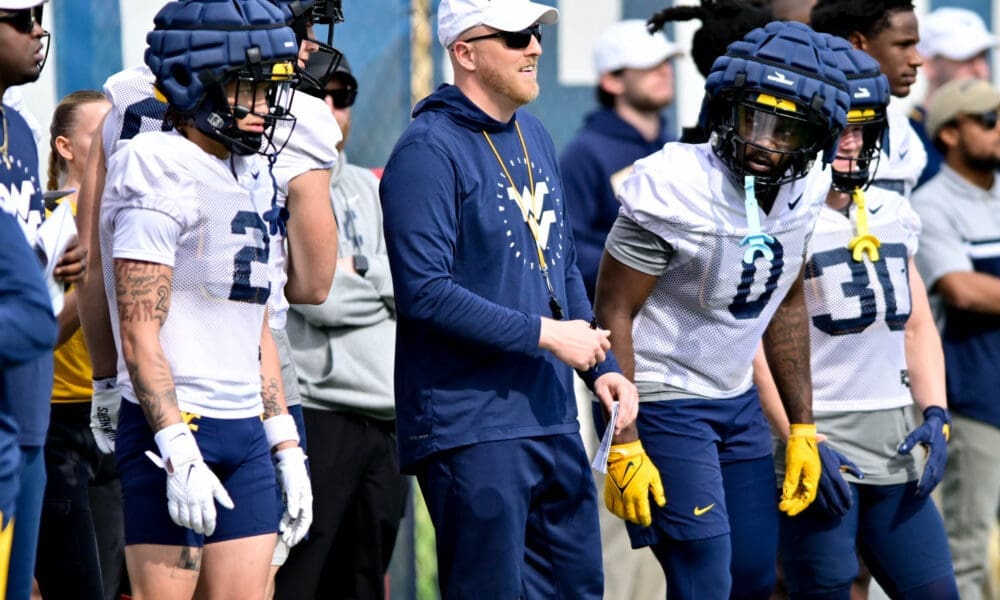 WVU Football TE Coach Blaine Stewart with players Rodney Gallagher and Jaylen Anderson