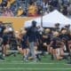 WVU Football Coach Noel Devine during warmups