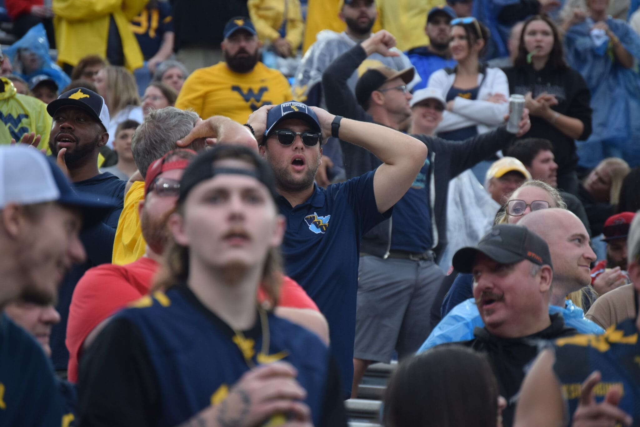 WVU Football fan hands on head during Utah game