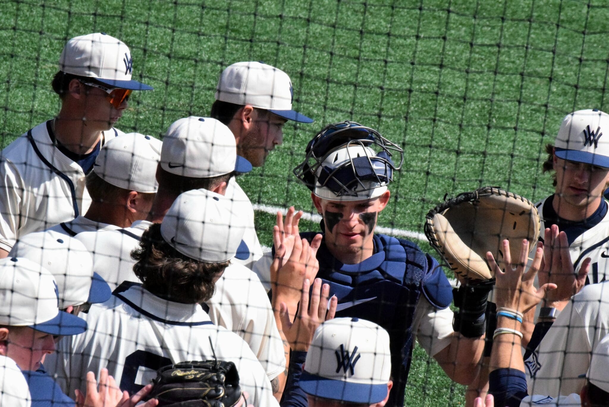 WVU Baseball players high fives
