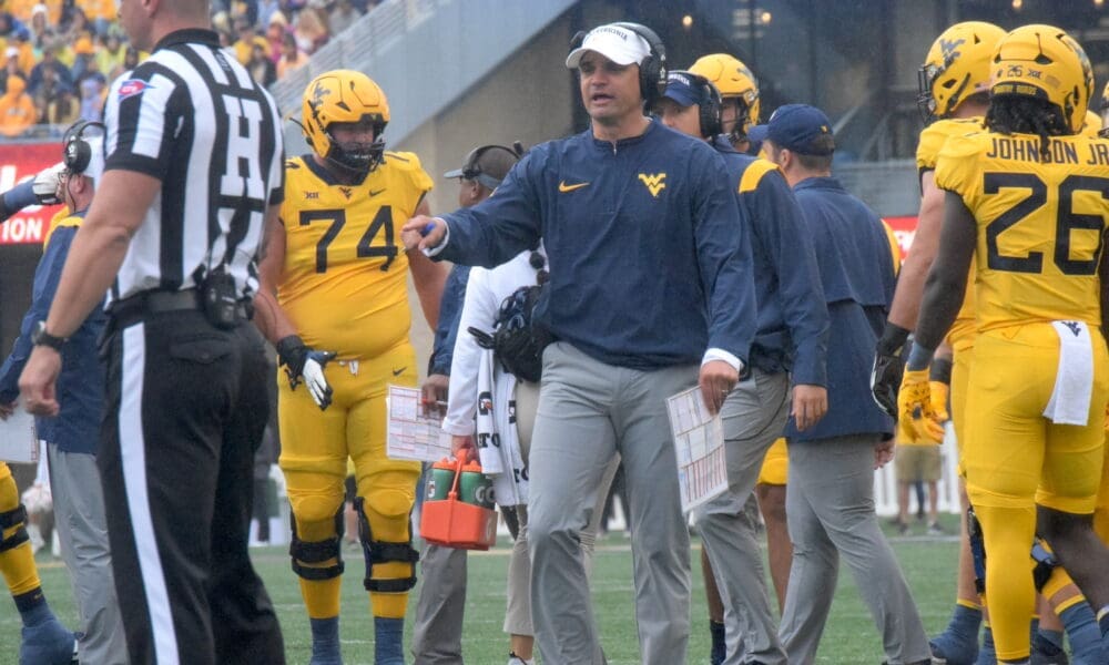 WVU Football HC Neal Brown and ref and Wyatt Milum
