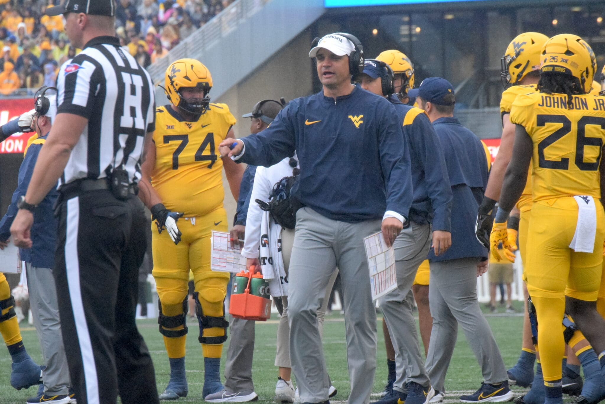 WVU Football HC Neal Brown and ref and Wyatt Milum