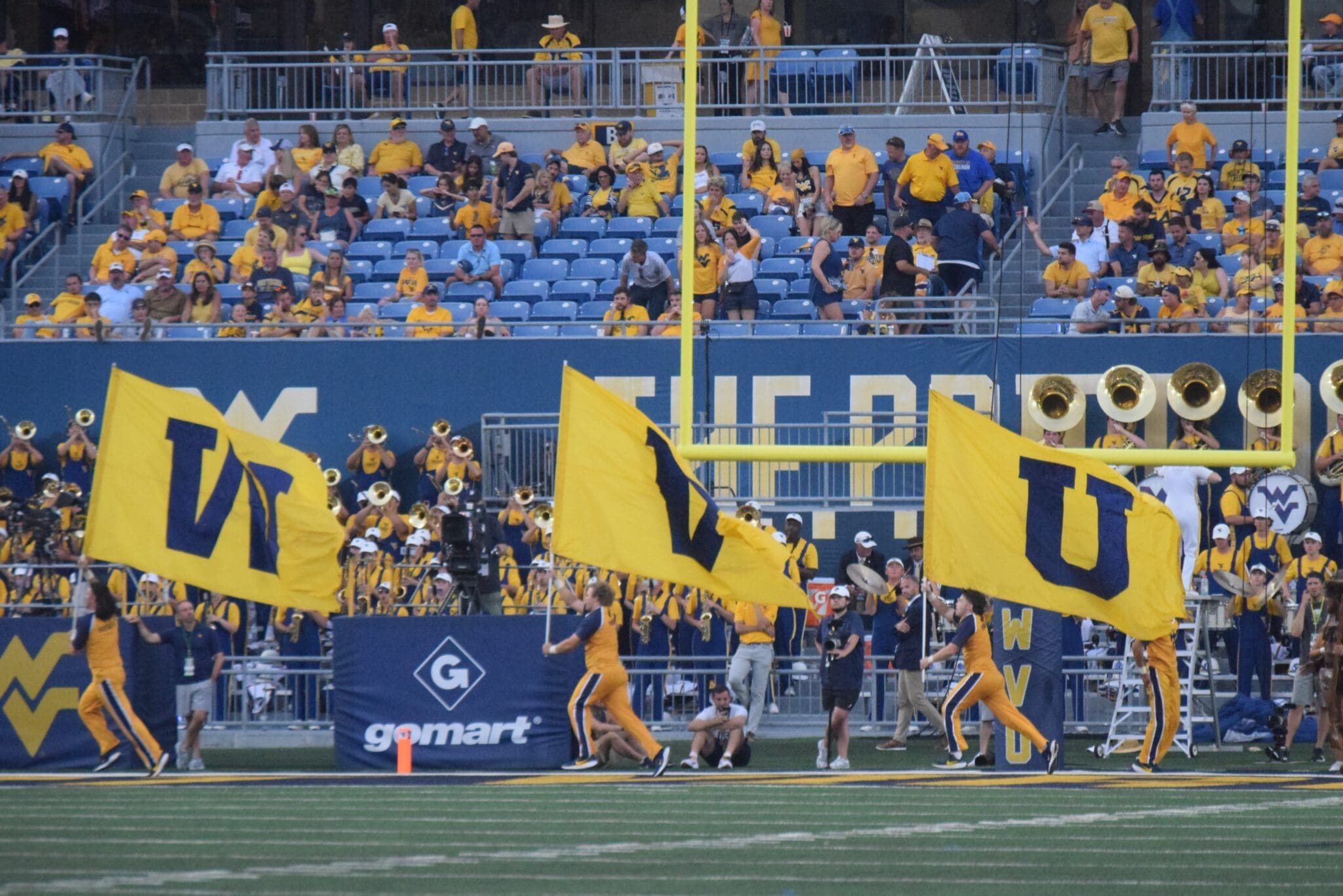 WVU Football flag on field after touchdown stock