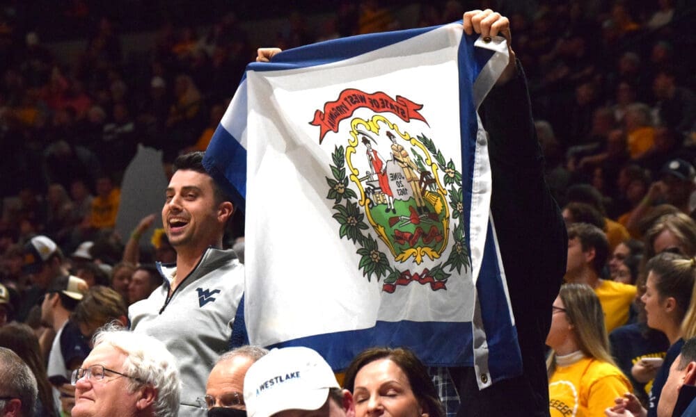 WVU fans with West Virginia flag