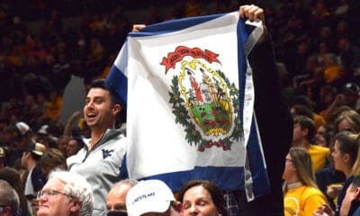 WVU fans with West Virginia flag