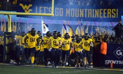 WVU Football team running on field Backyard Brawl