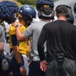 Neal Brown huddling with offense