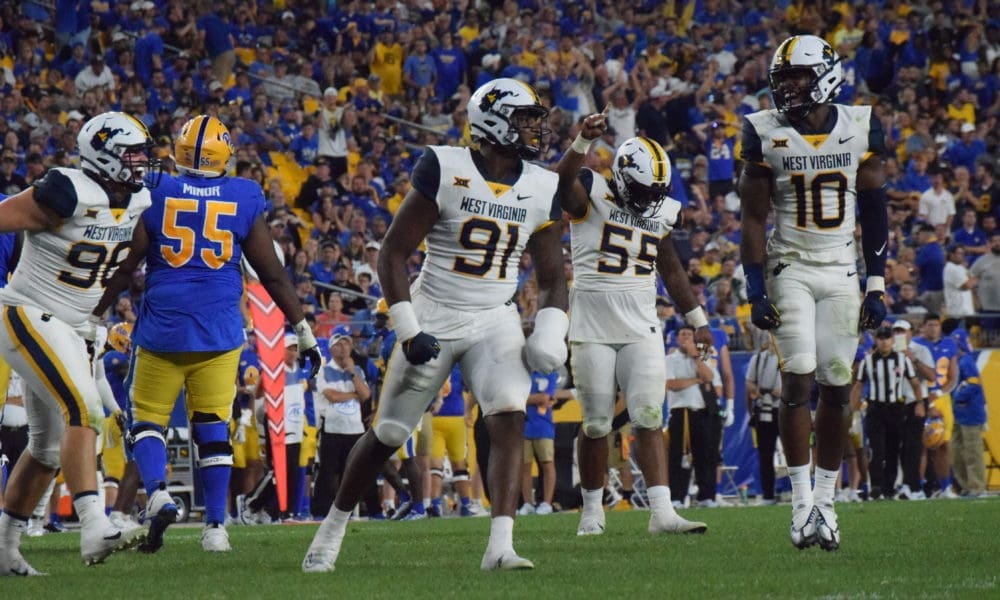 WVU football defense of Sean Martin, Dante Stills and Jared Bartlett