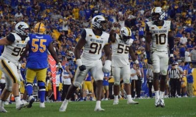 WVU football defense of Sean Martin, Dante Stills and Jared Bartlett
