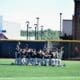 WVU Baseball players huddle on field before Morgantown Regional