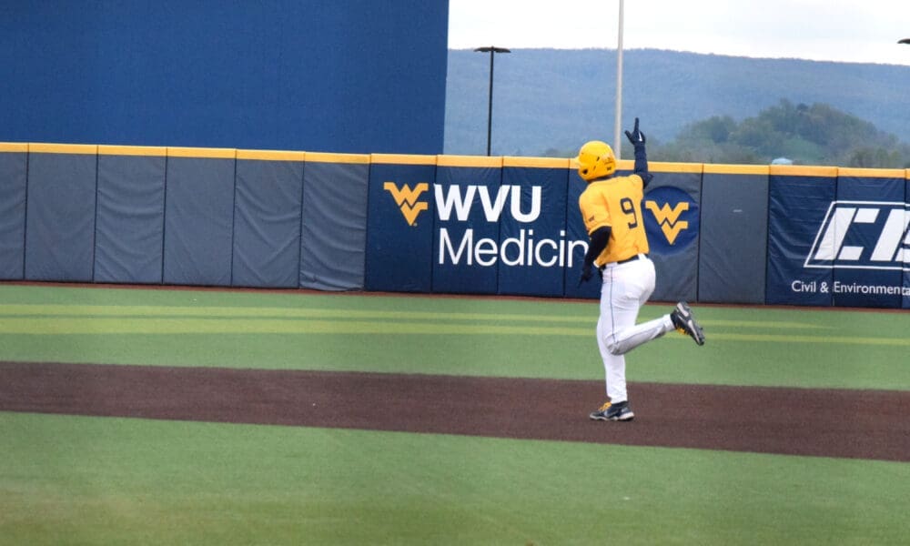 WVU Baseball first baseman Grant Hussey waves after a home run.