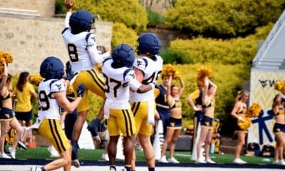 WVU Football defense including Kamari Wilson celebrating during scrimmage