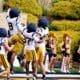 WVU Football defense including Kamari Wilson celebrating during scrimmage
