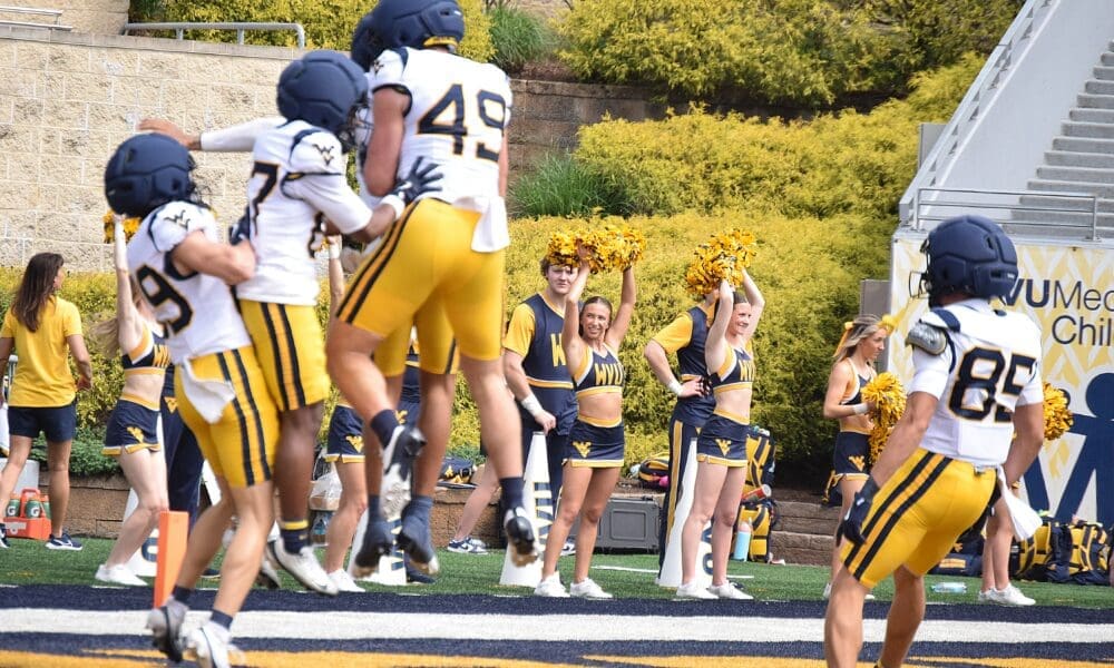 WVU Football offense with Carter Zuliani celebrating during scrimmage
