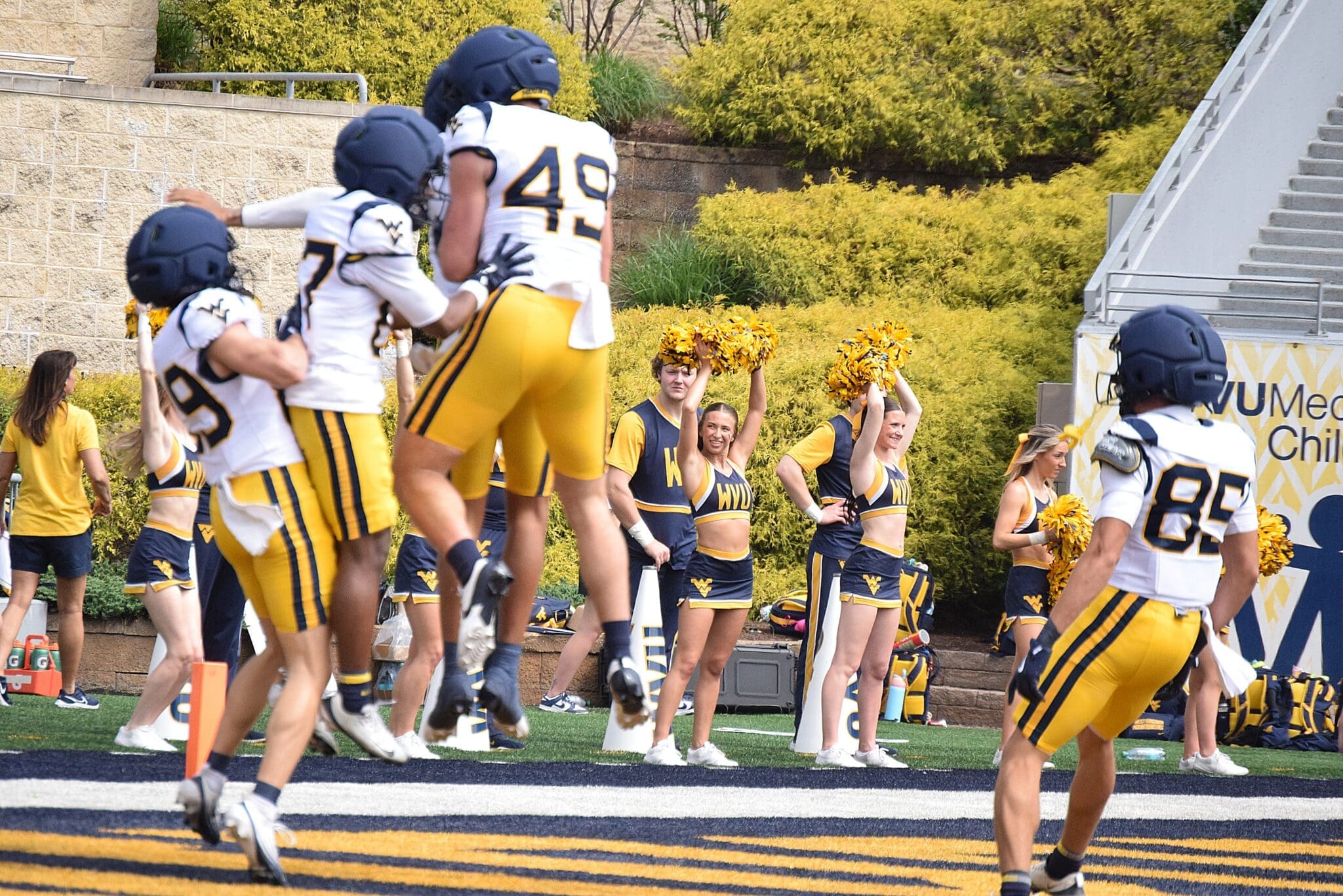 WVU Football offense with Carter Zuliani celebrating during scrimmage