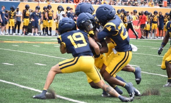 WVU Football CB Nick Taylor and others make a tackle during scrimmage