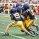 WVU Football CB Nick Taylor and others make a tackle during scrimmage