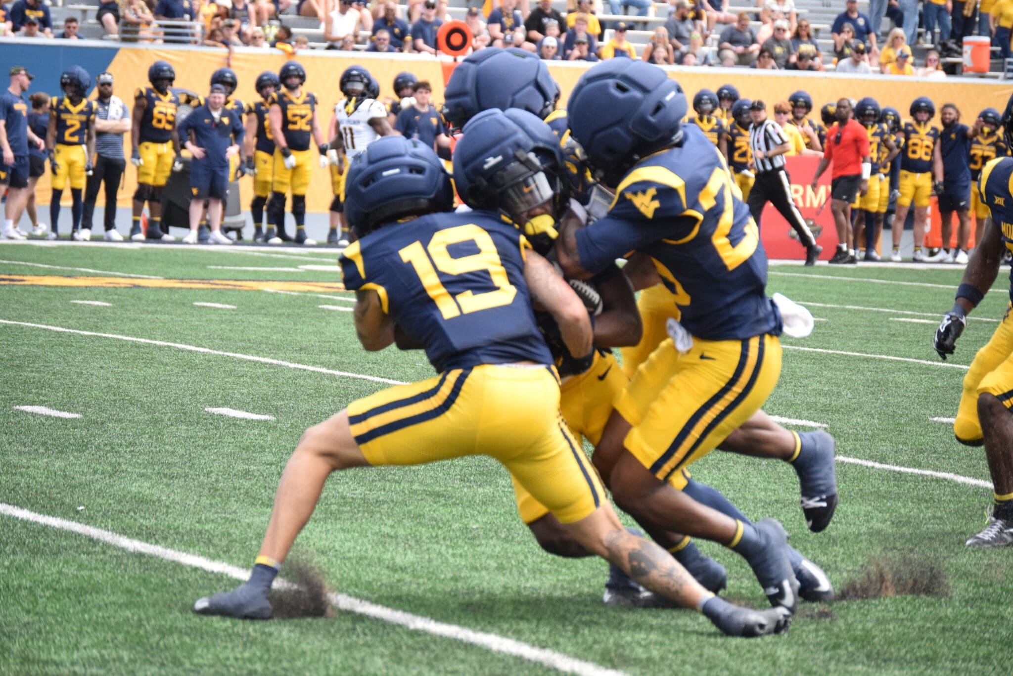 WVU Football CB Nick Taylor and others make a tackle during scrimmage