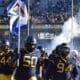WVU Football players carrying flag