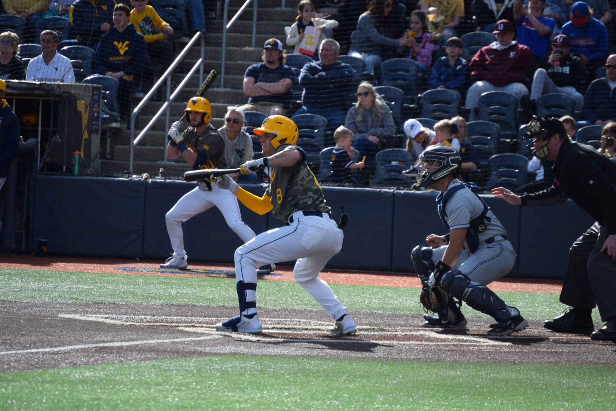 WVU baseball catcher Dayne Leonard drops a bunt.
