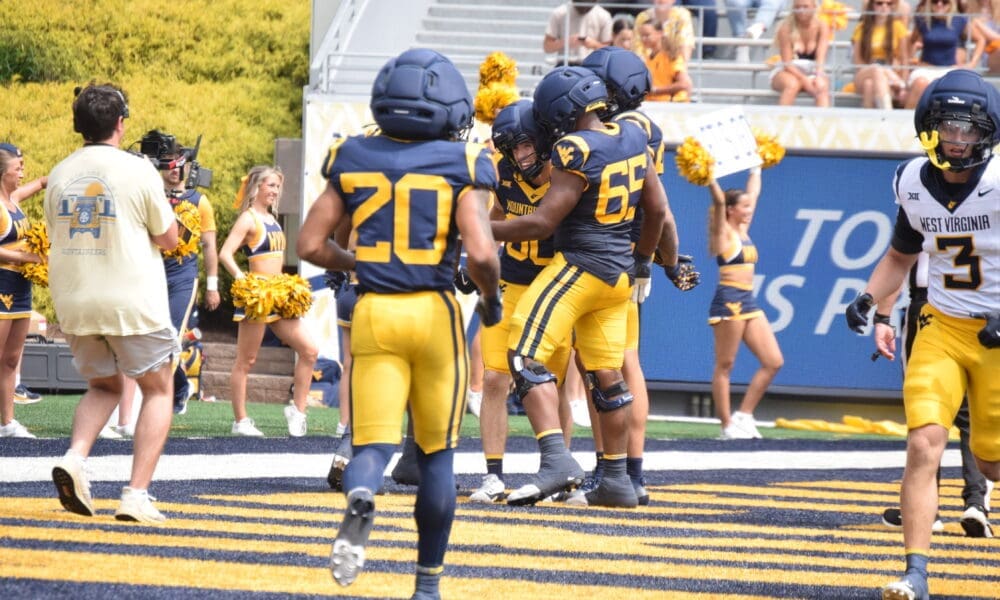 WVU Football RB Martavious Boswell runs to celebrate TD in end zone of scrimmage