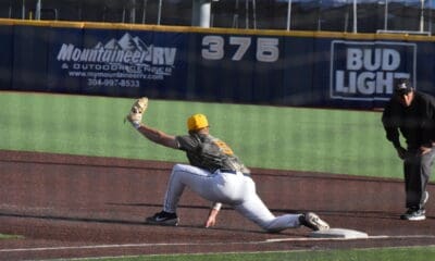WVU baseball first baseman Grant Hussey stretches for the putout.