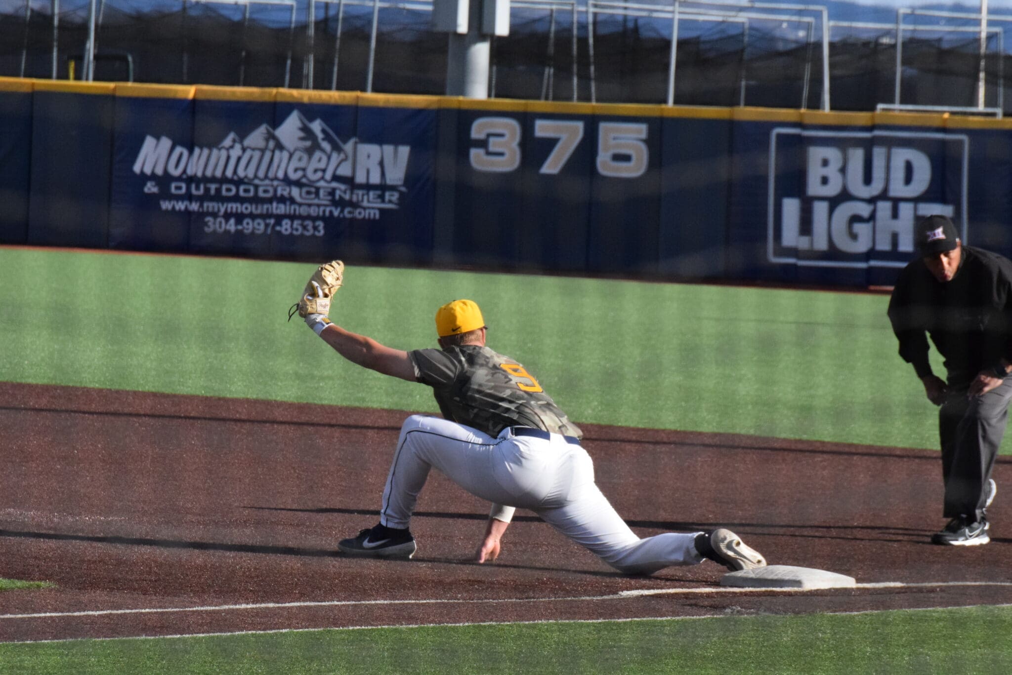 WVU baseball first baseman Grant Hussey stretches for the putout.