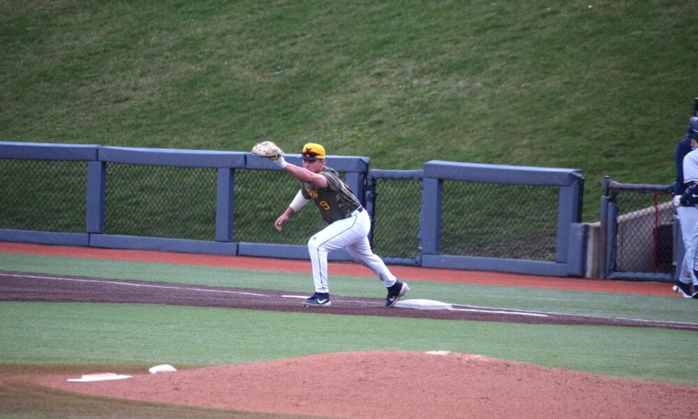 WVU Baseball first baseman Grant Hussey stretches for a catch.