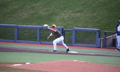 WVU Baseball first baseman Grant Hussey stretches for a catch.