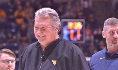 Bob Huggins smiling and Josh Eilert