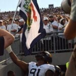 WVU Football Sean Martin waving state flag