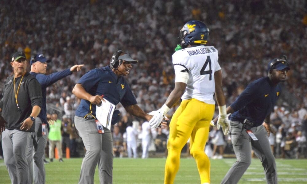 WVU Football RB CJ Donaldson and coaches Chad Scott, Bilal Marshall