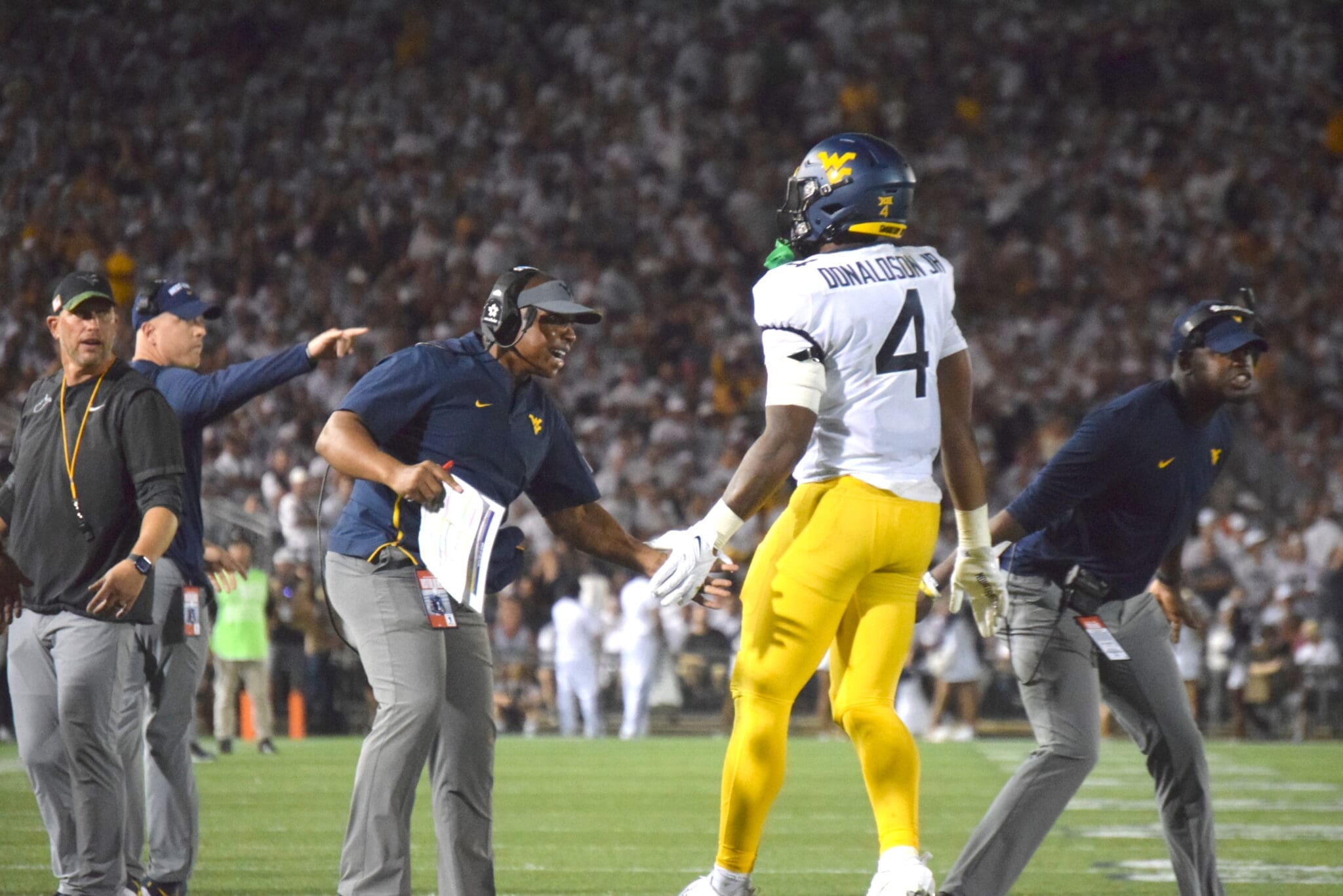 WVU Football RB CJ Donaldson and coaches Chad Scott, Bilal Marshall