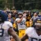 WVU Football team celebrate after Ethan Head makes kick at practice