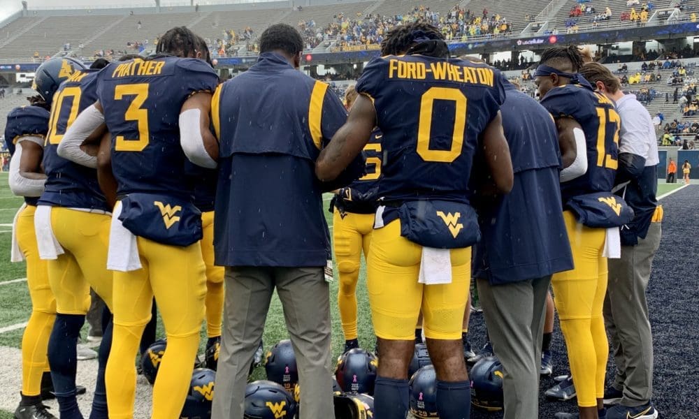 WVU Football team huddle