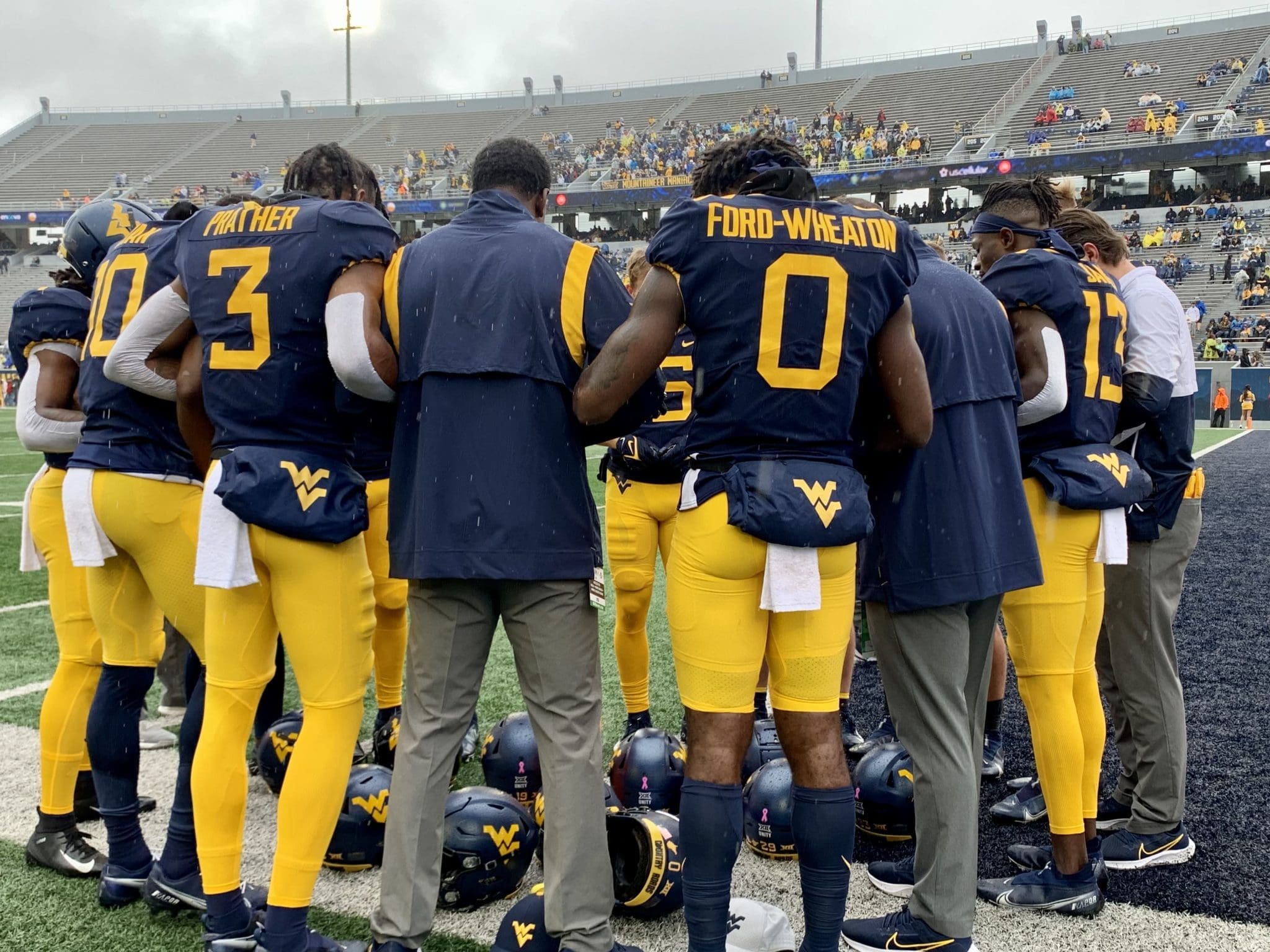 WVU Football team huddle
