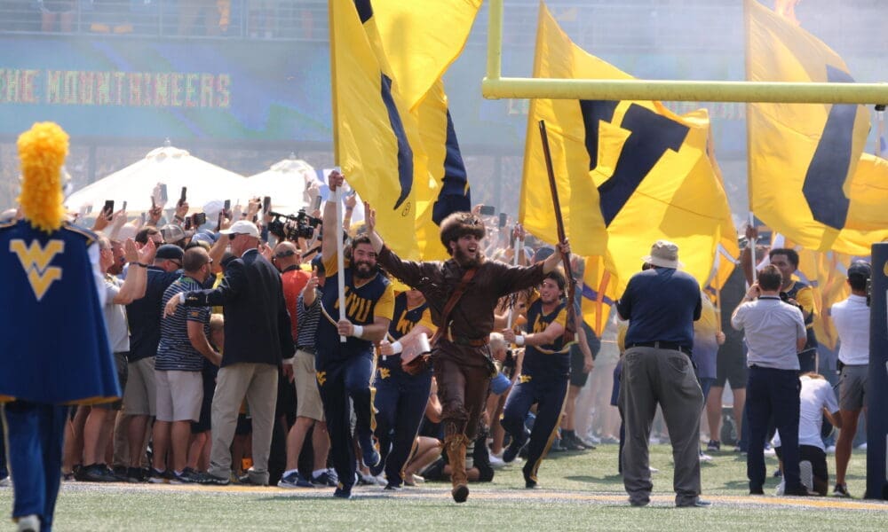 WVU Mountaineer Mascot runs on field before WVU Football game stock