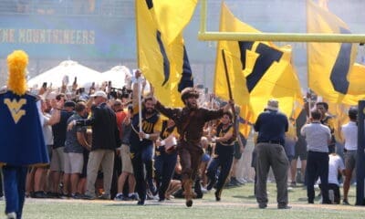 WVU Mountaineer Mascot runs on field before WVU Football game stock